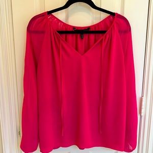 White House Black Market bright pink blouse with sheer sleeves and lace detail.